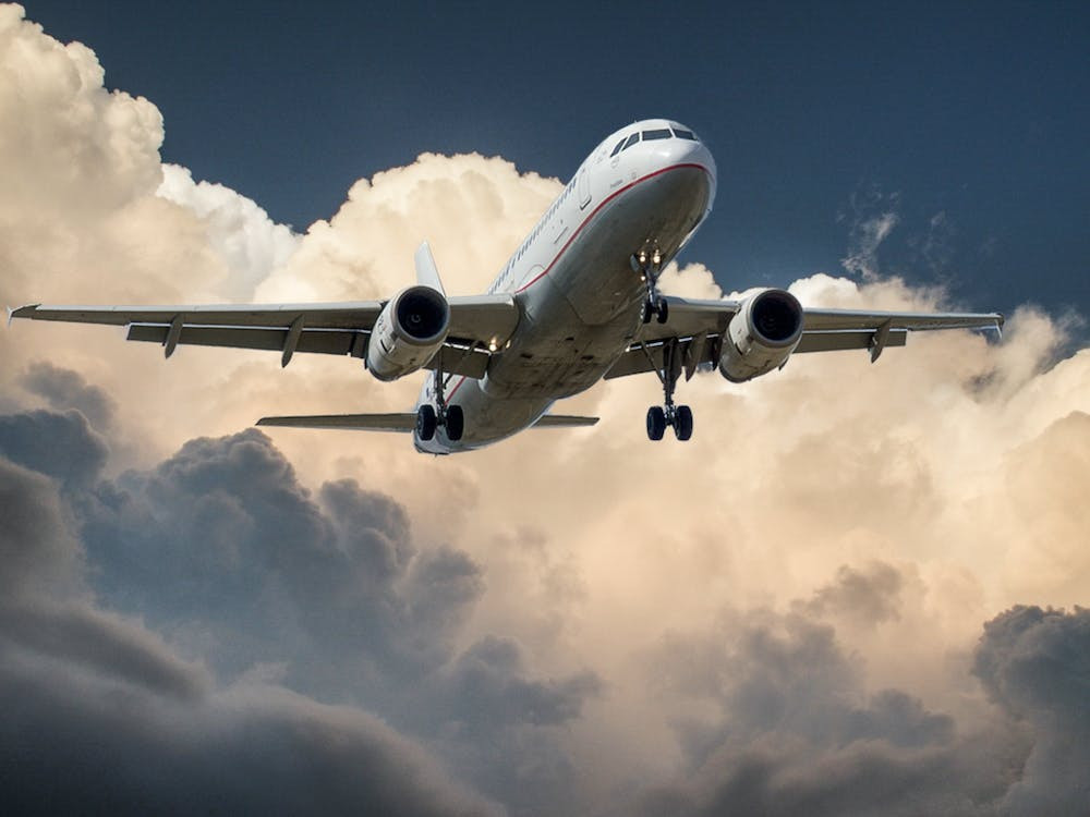 airplane beside clouds